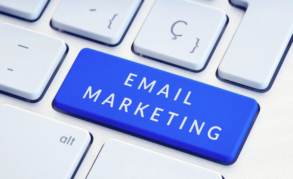 Blue keyboard key labeled "EMAIL MARKETING" with surrounding gray keys.